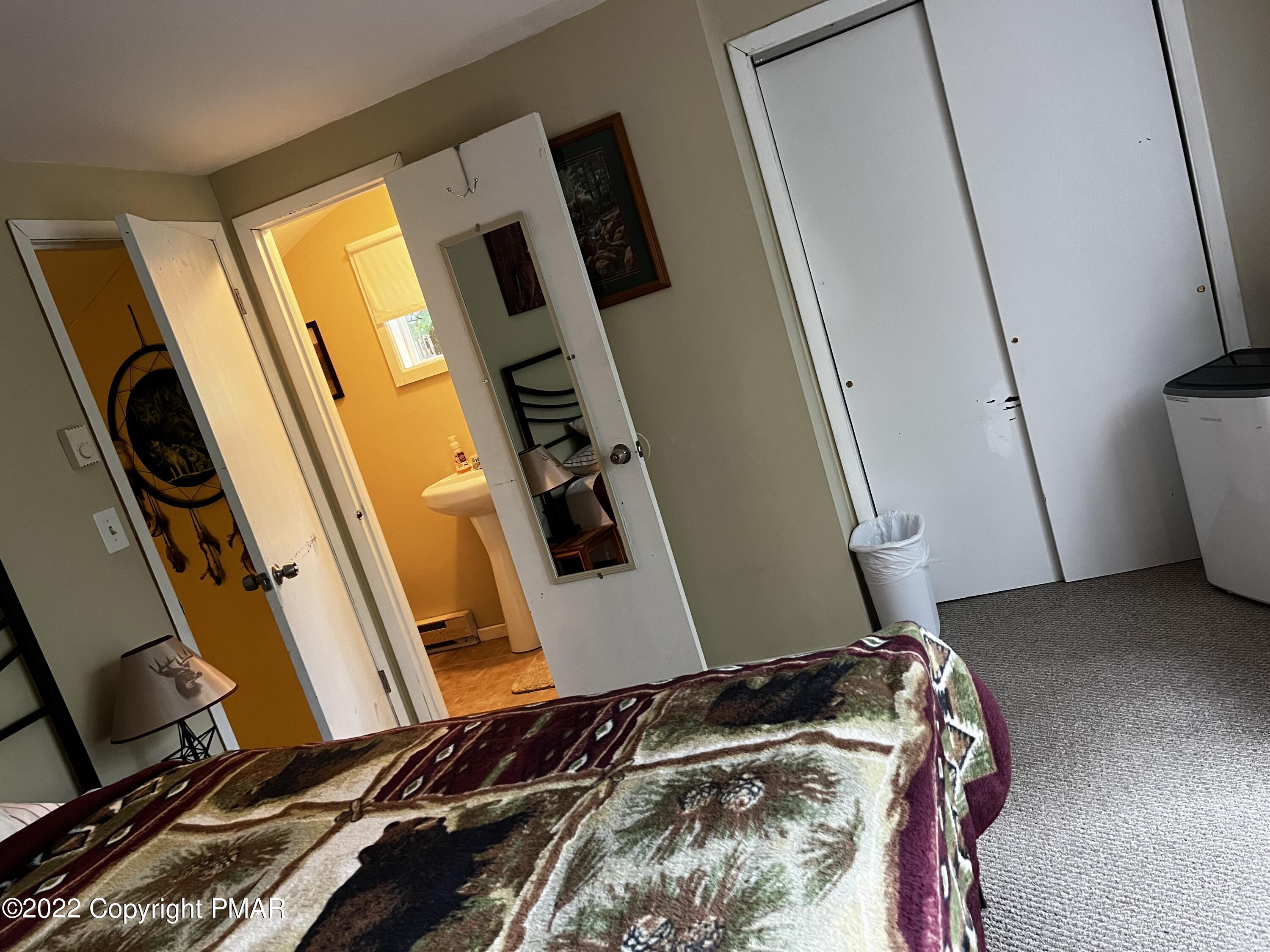 153 Edinburgh Road Bushkill, PA 18324 - Photo 17 of 24 a bedroom with a bed and a flat tv screen