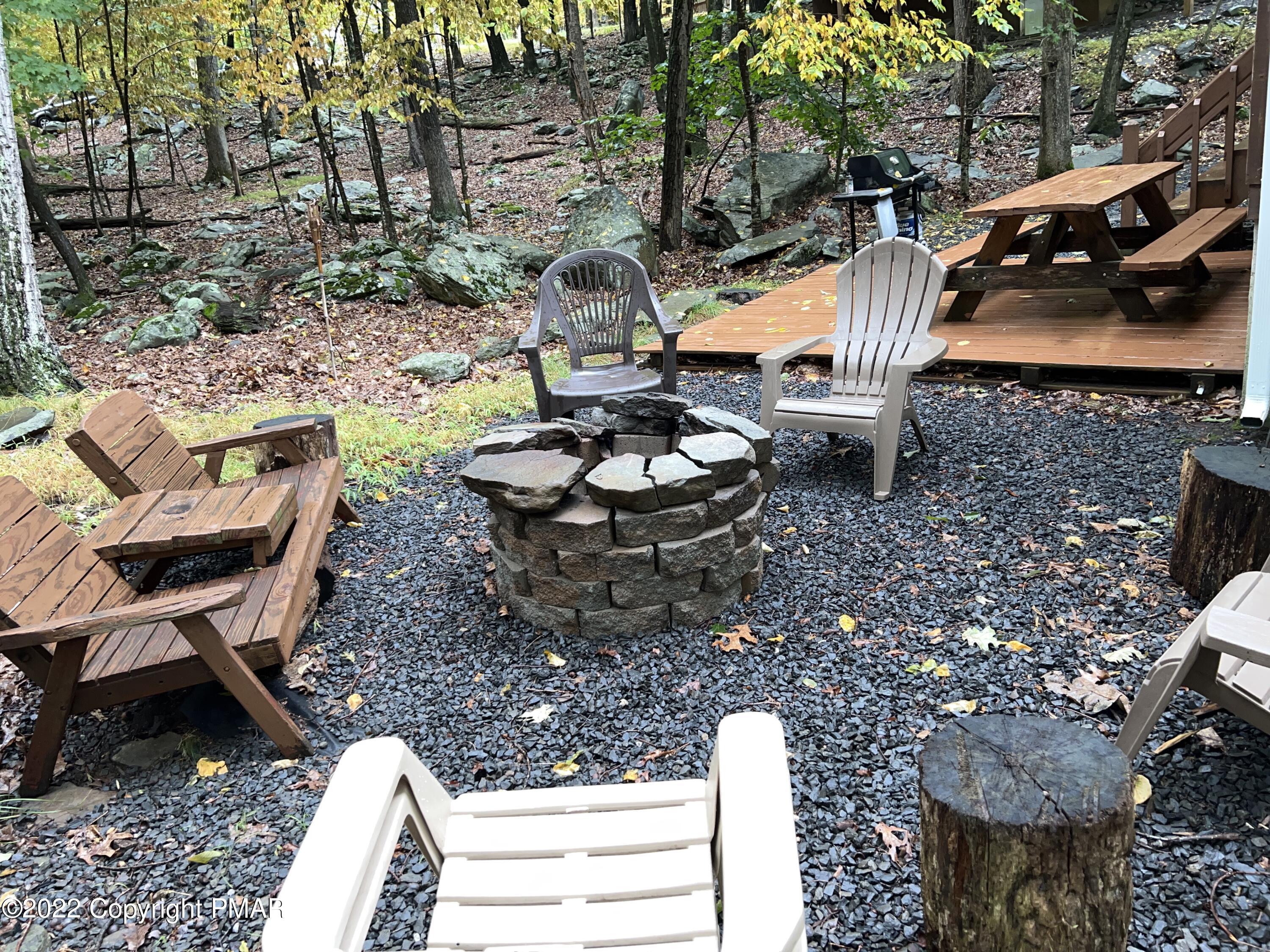 153 Edinburgh Road Bushkill, PA 18324 - Photo 24 of 24 a backyard of a house with barbeque oven table and chairs