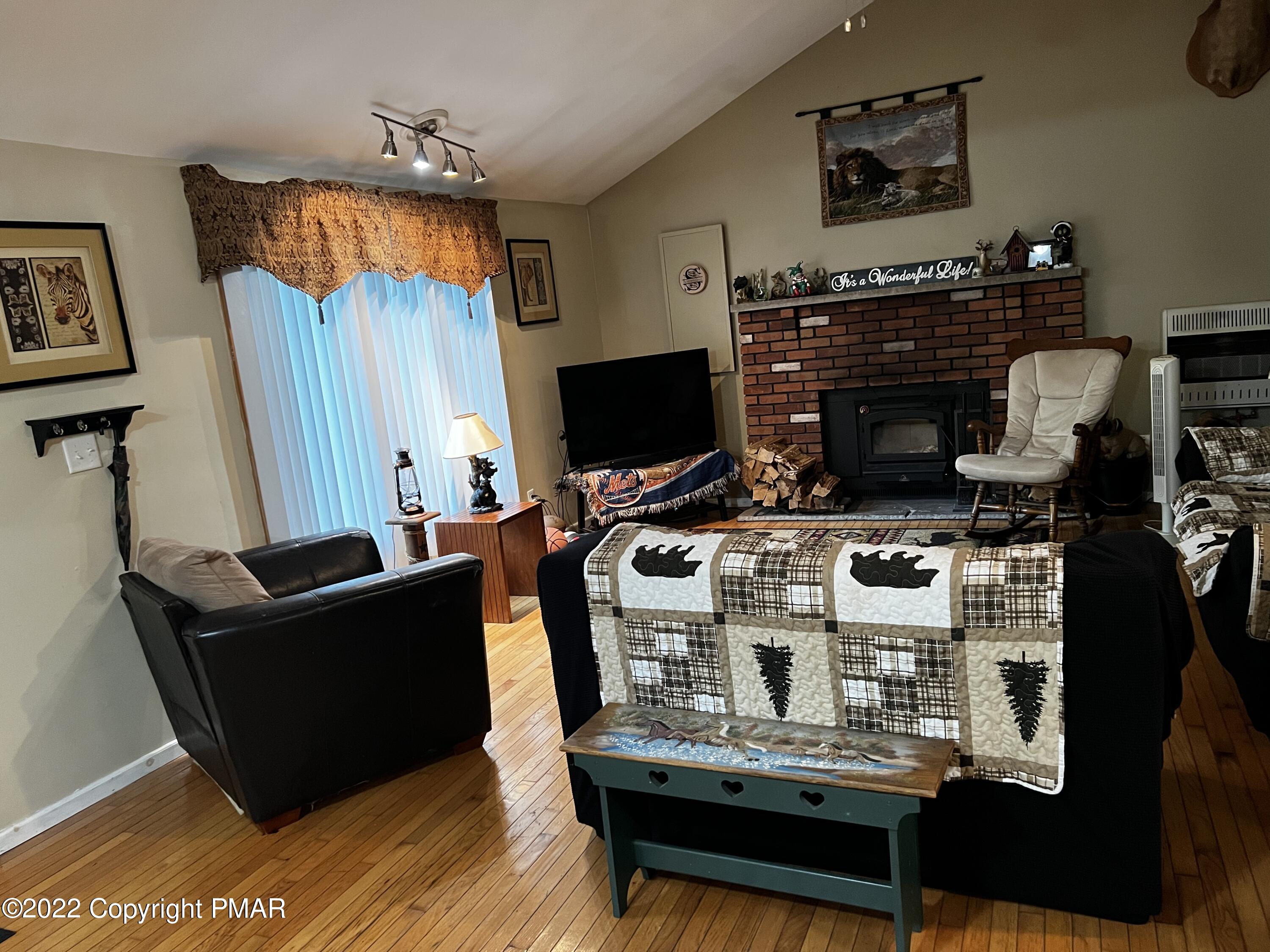 153 Edinburgh Road Bushkill, PA 18324 - Photo 6 of 24 a living room with furniture and a fireplace