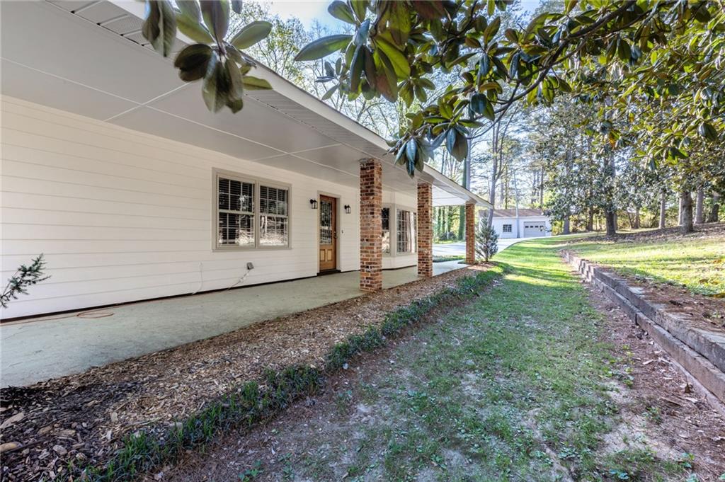 143 Swanson Road Fayetteville, GA 30214 - Photo 24 of 27 a view of a yard with plants and a tree