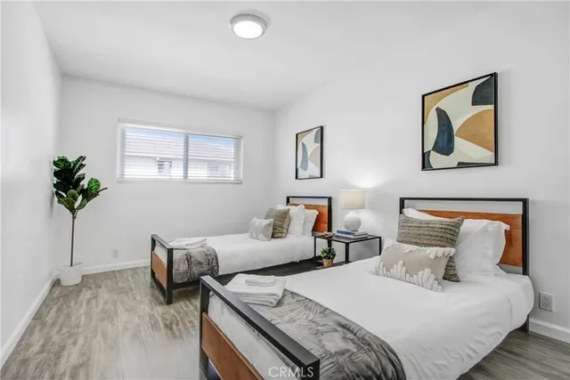 a bedroom with bed and a potted plant