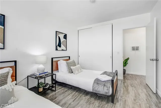 a bedroom with a bed and wooden floor