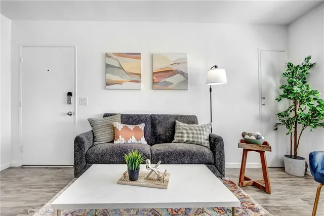 a living room with furniture and a potted plant