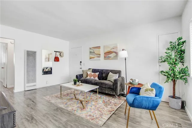 a living room with furniture and a potted plant