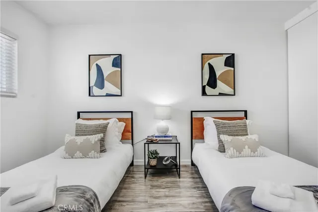 a bedroom with a bed and glass wall