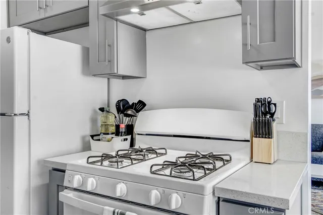 a kitchen with stainless steel appliances granite countertop a sink and a stove