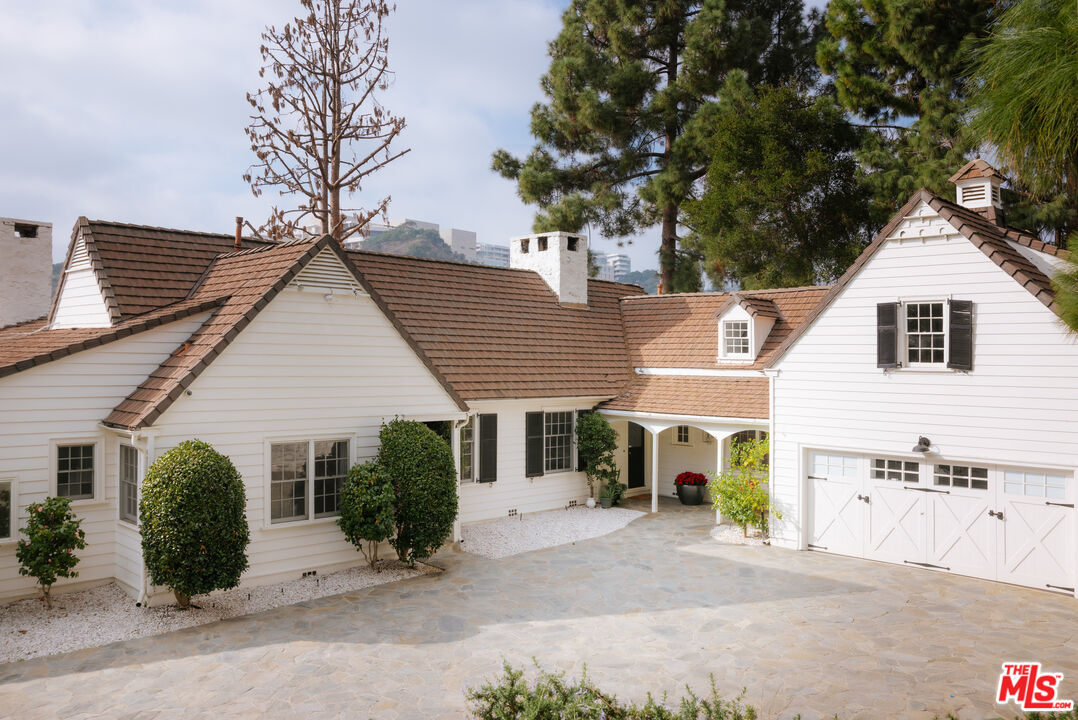 11630 Bellagio Road Los Angeles, CA 90049 - Photo 1 of 18 a view of a house with a patio