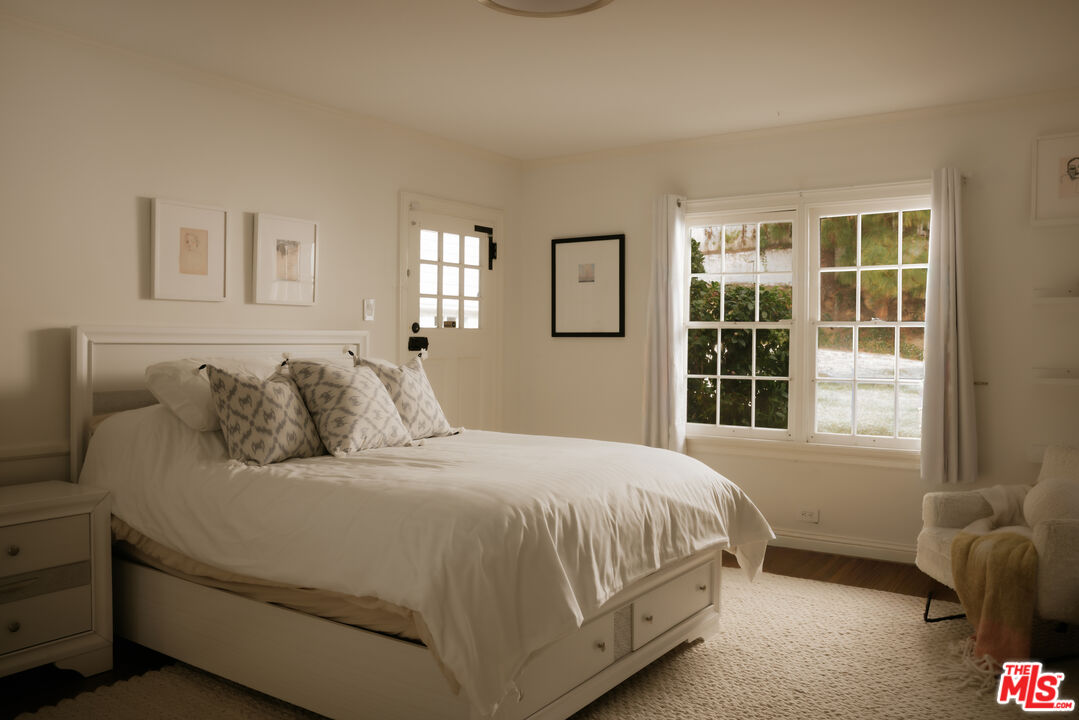 11630 Bellagio Road Los Angeles, CA 90049 - Photo 12 of 18 a bedroom with a bed and a window