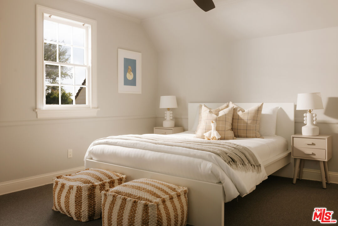11630 Bellagio Road Los Angeles, CA 90049 - Photo 14 of 18 a bedroom with a bed and wooden floor