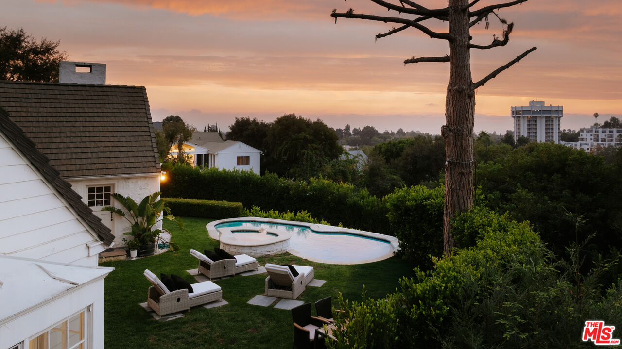 11630 Bellagio Road Los Angeles, CA 90049 - Photo 16 of 18 a view of a chairs and table in backyard