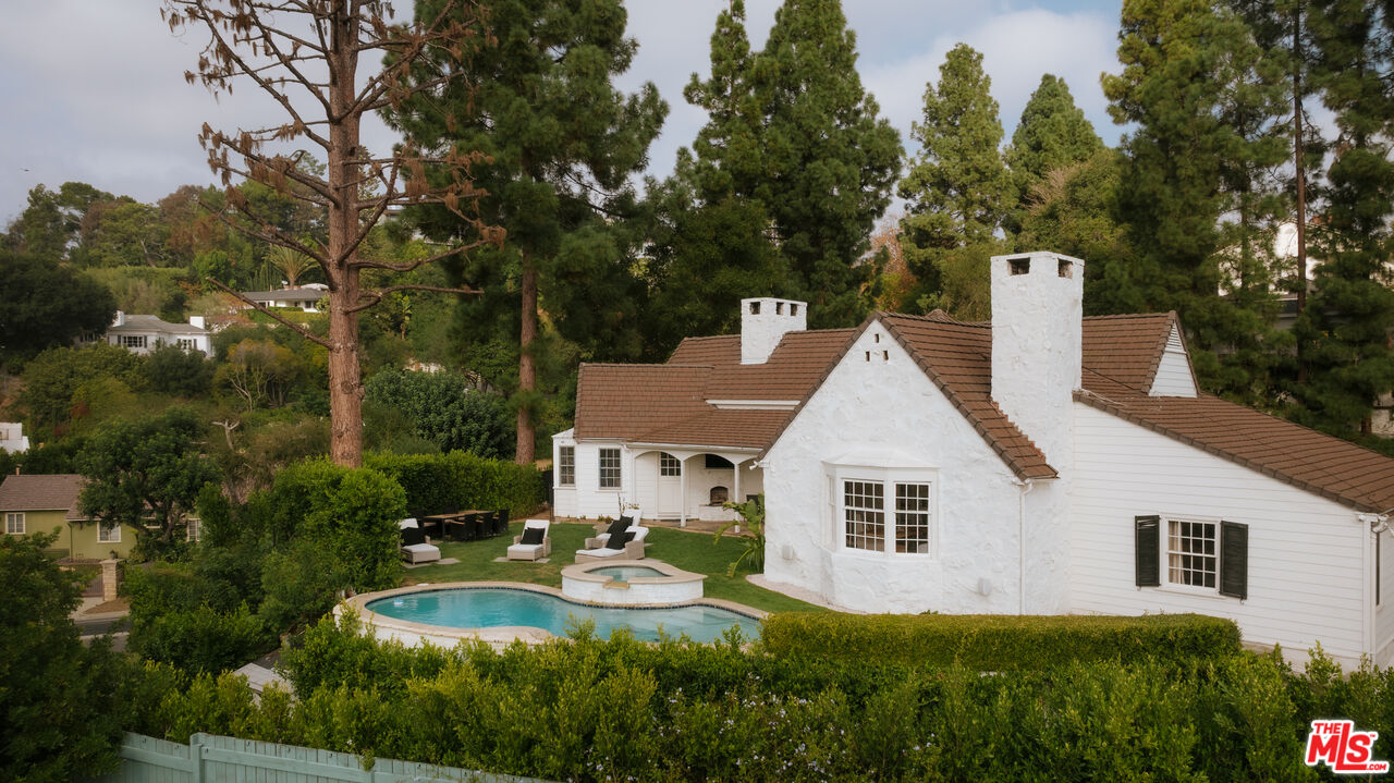 11630 Bellagio Road Los Angeles, CA 90049 - Photo 17 of 18 a view of backyard of house with green space