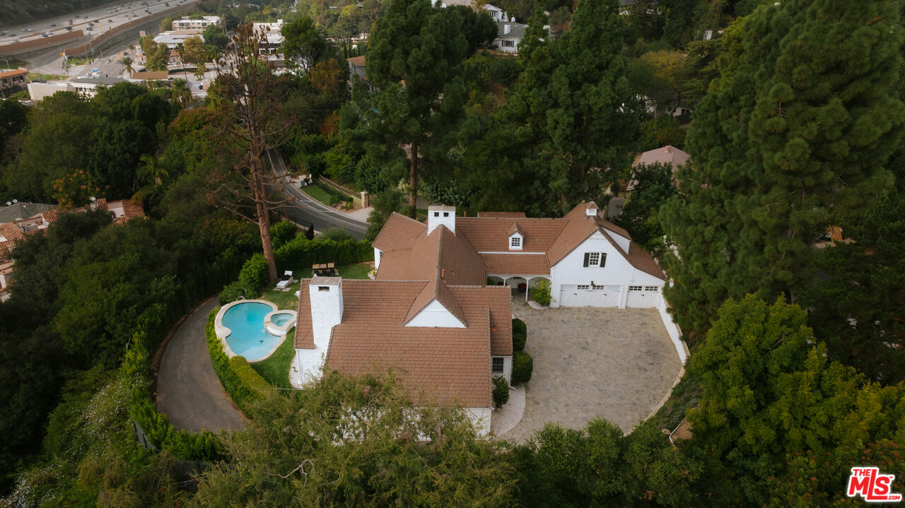 11630 Bellagio Road Los Angeles, CA 90049 - Photo 18 of 18 an aerial view of a house with a yard and trees
