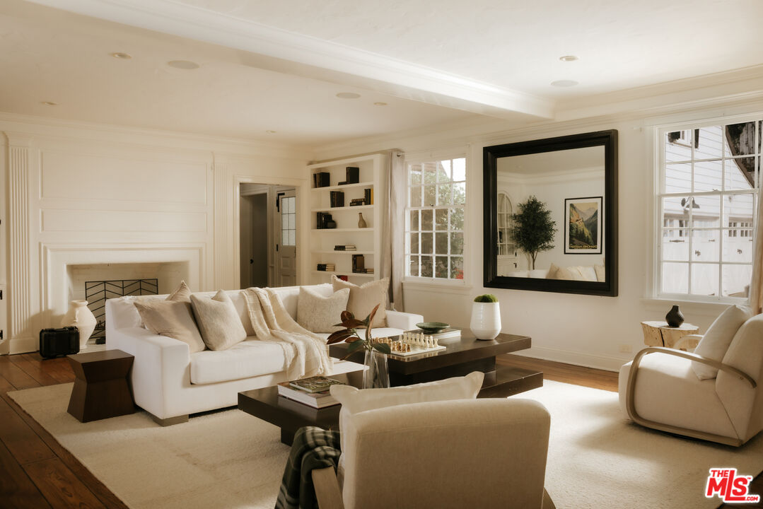 11630 Bellagio Road Los Angeles, CA 90049 - Photo 2 of 18 a living room with furniture and a window