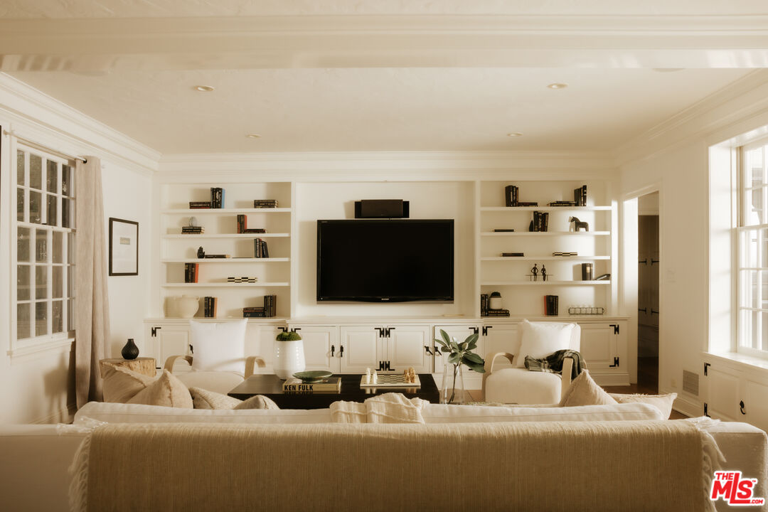 11630 Bellagio Road Los Angeles, CA 90049 - Photo 3 of 18 a living room with furniture and a flat screen tv