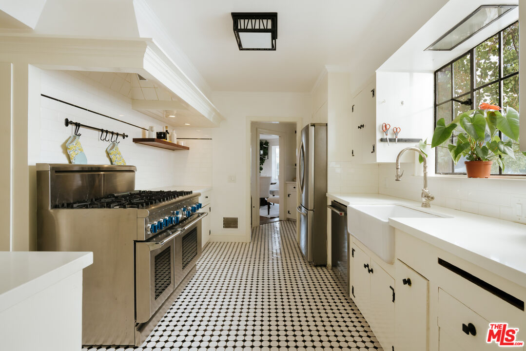 11630 Bellagio Road Los Angeles, CA 90049 - Photo 5 of 18 a kitchen with a stove and a sink