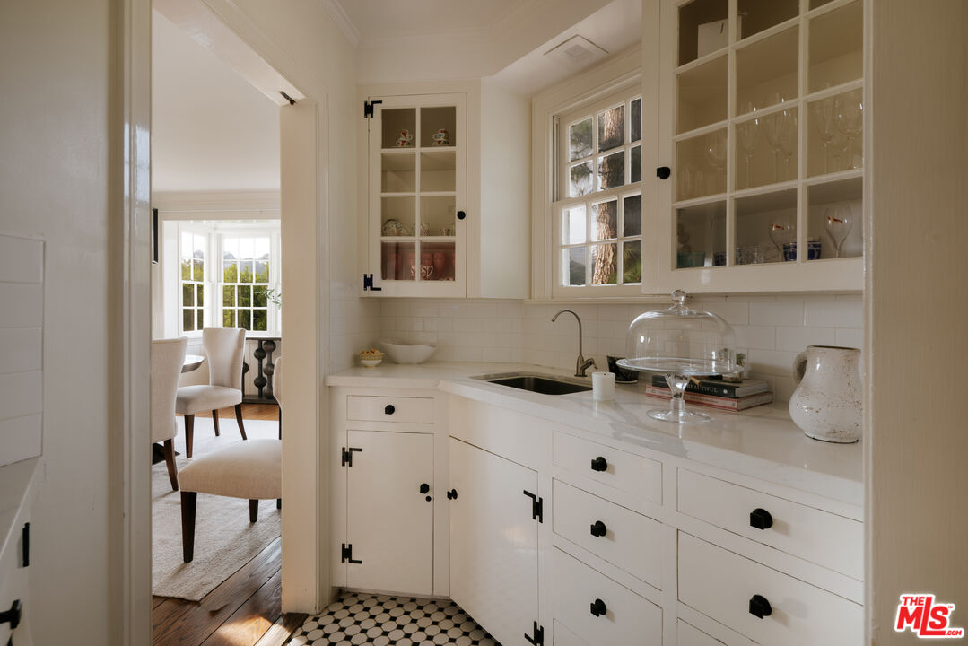 11630 Bellagio Road Los Angeles, CA 90049 - Photo 6 of 18 a kitchen with a sink and cabinets