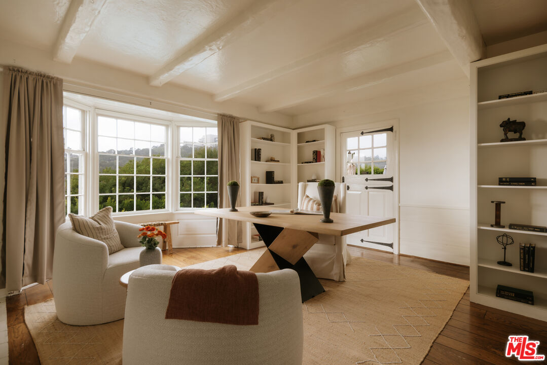 11630 Bellagio Road Los Angeles, CA 90049 - Photo 7 of 18 a living room with furniture large window and a table