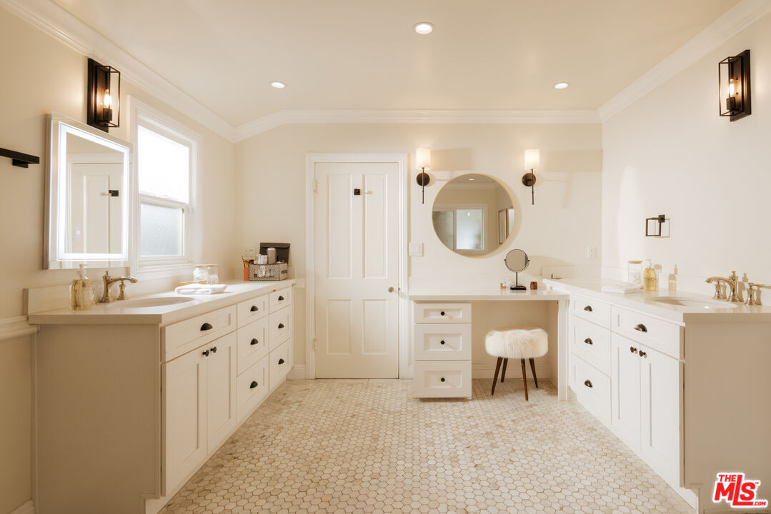 11630 Bellagio Road Los Angeles, CA 90049 - Photo 10 of 18 a spacious bathroom with double vanity a sink a mirror a vanity and a