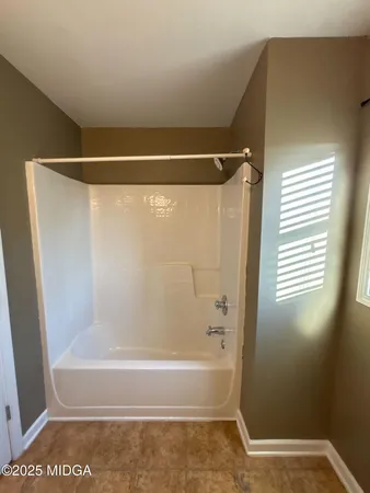 a bathroom with a shower and a bath tub