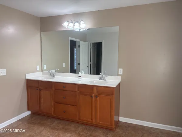 a bathroom with a double vanity sink and a mirror