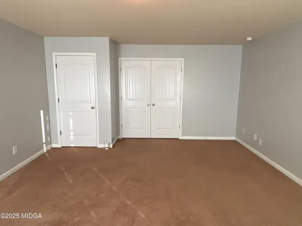 a view of an empty room and closet