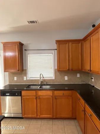 a kitchen with granite countertop a sink and a granite counter tops