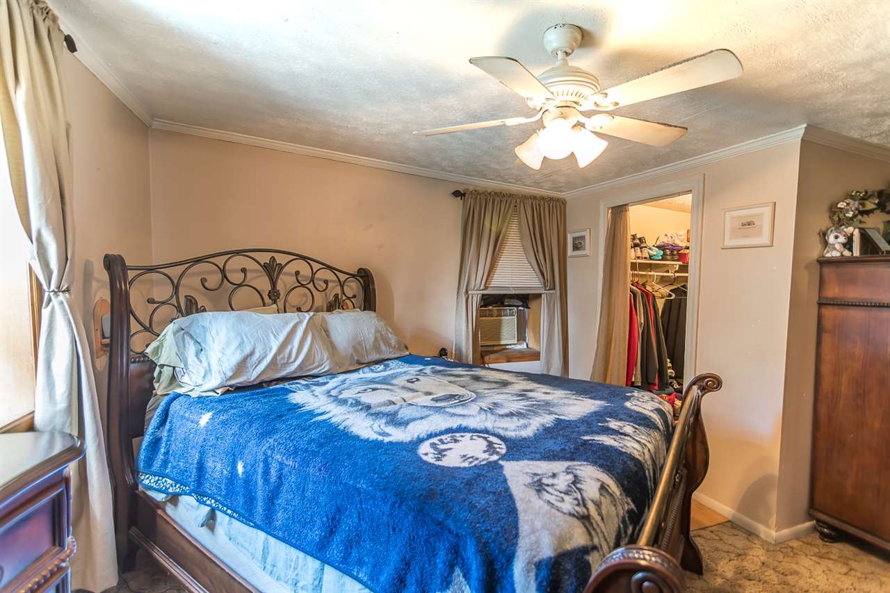 3672 Middlebrook Village Road Middlebrook, VA 24459 - Photo 40 of 45 a bedroom with a bed and a chandelier