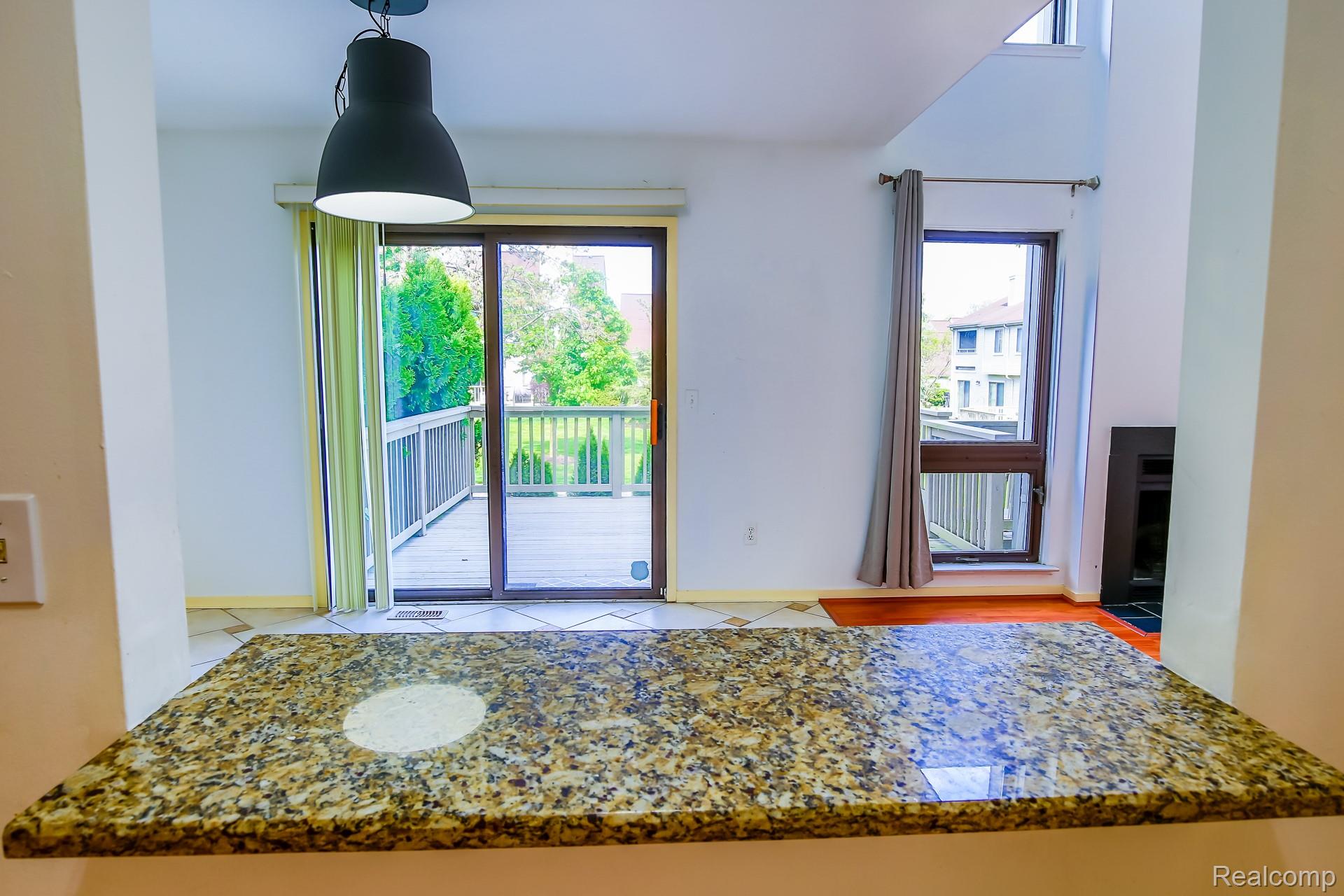 716 Eton Court Rochester, MI 48307 - Photo 21 of 41 Kitchen bar look through the deck