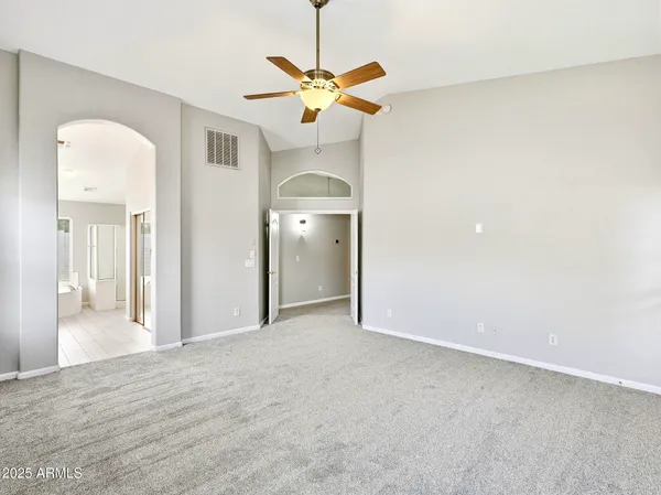 a view of a livingroom with a ceiling fan and wooden floor