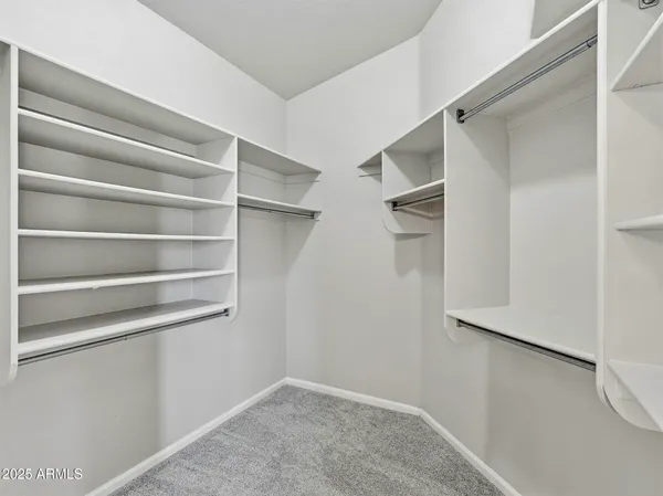 a view of walk in closet with empty racks