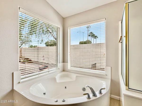 a bathroom with a bathtub and a window