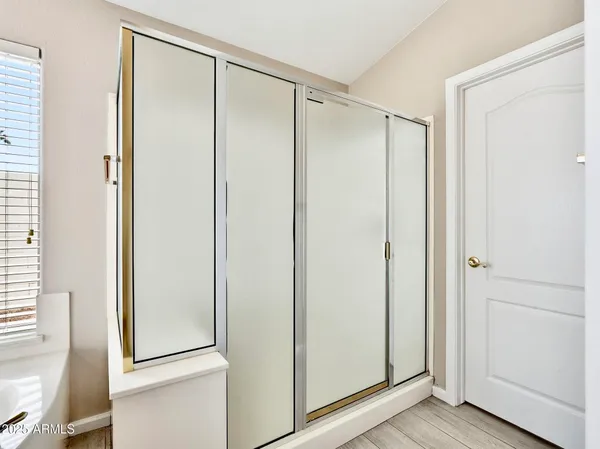 a bathroom with a glass shower door
