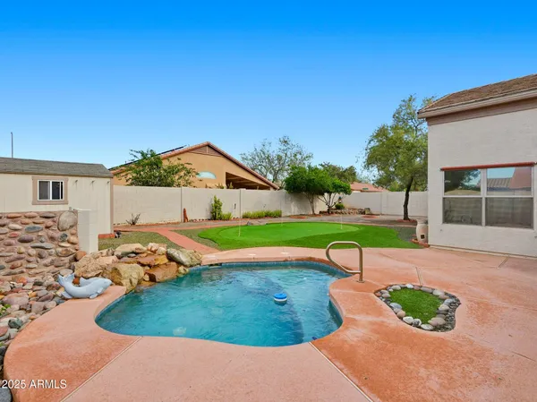 a view of yard with swimming pool and outdoor seating