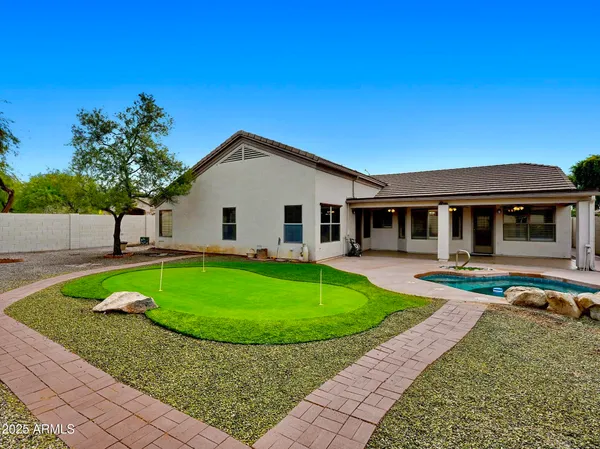 a view of a house with a backyard