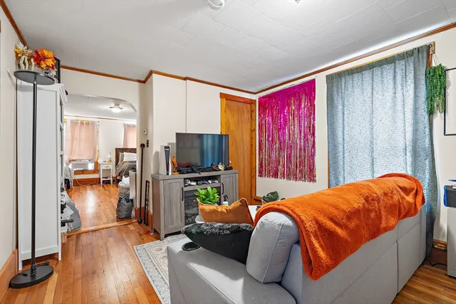 a bedroom with a bed and a television