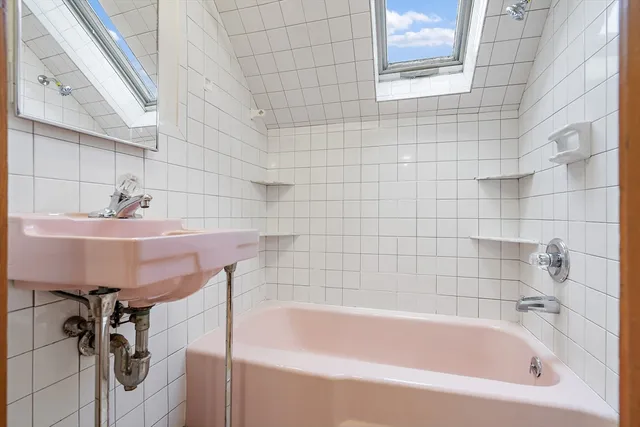 a white bath tub sitting next to a white sink