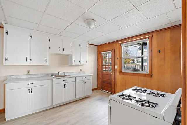 a kitchen with stainless steel appliances granite countertop a stove sink and cabinets