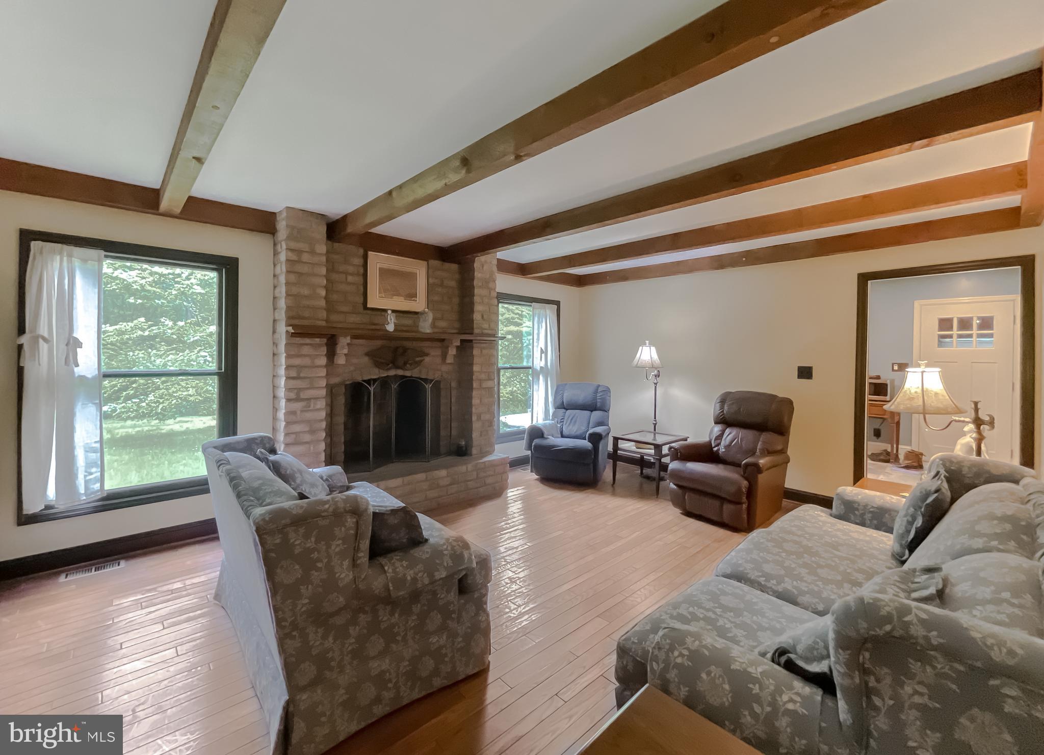 621 Bowie Shop Road Huntingtown, MD 20639 - Photo 7 of 56 Living room with fireplace and exposed beams