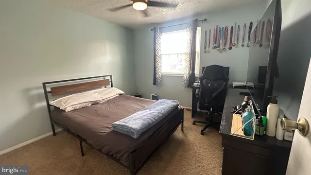 a bedroom with a bed and a desk