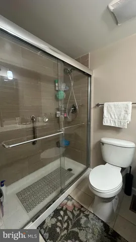a bathroom with a toilet and a shower