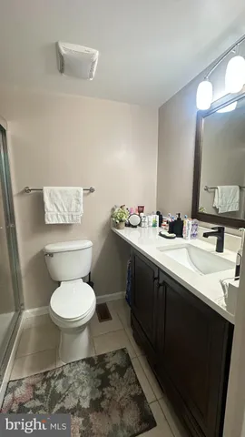 a bathroom with a sink toilet mirror and vanity