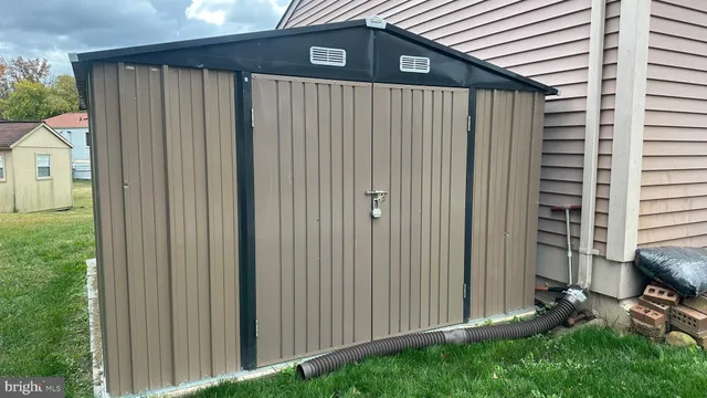 a backyard of a house with table and chairs