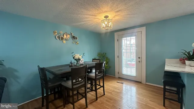 a view of a dining room with furniture and chandelier