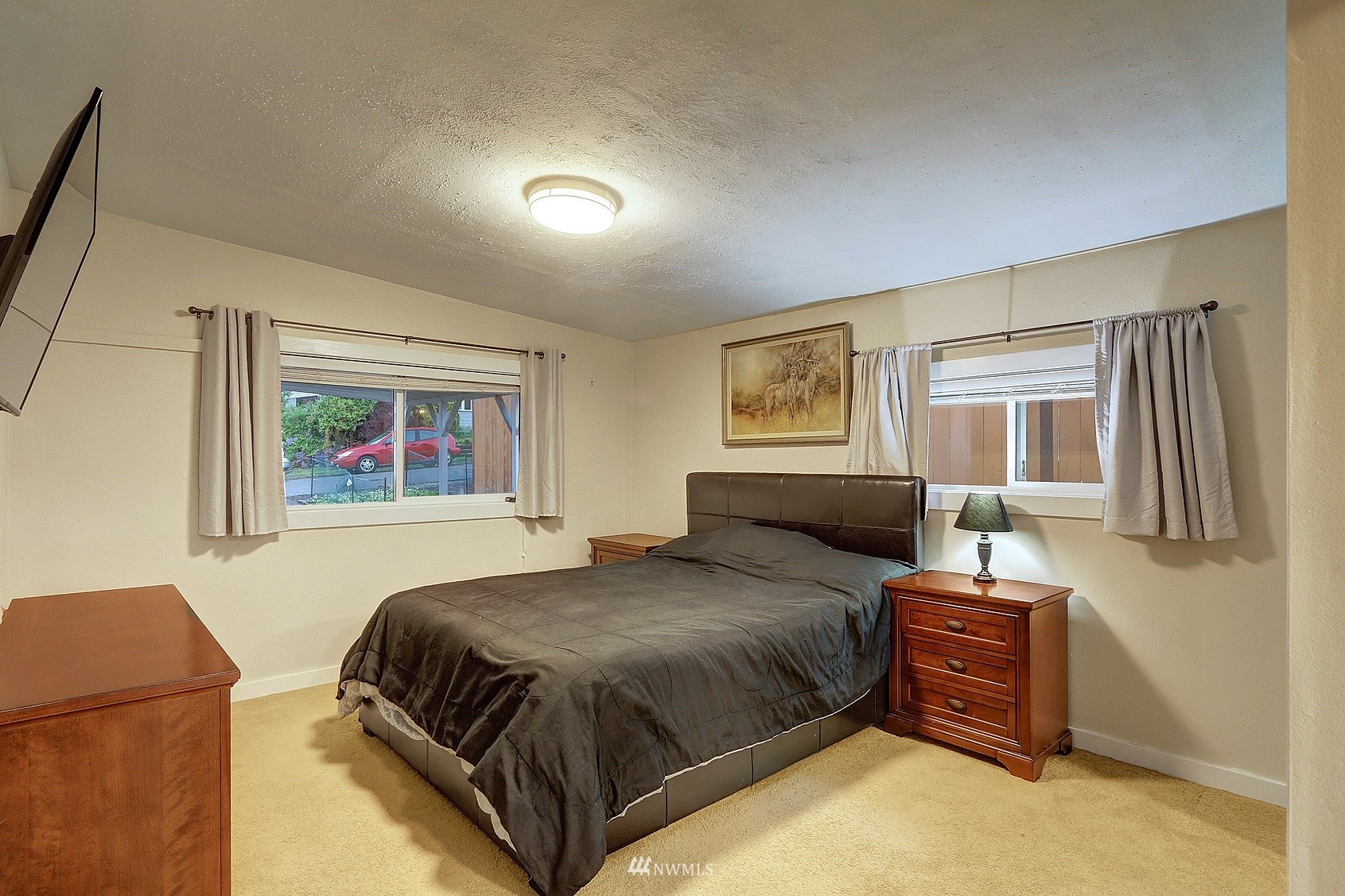 2209 Northeast 8th Street Renton, WA 98056 - Photo 11 of 24 a bedroom with a bed and wooden floor