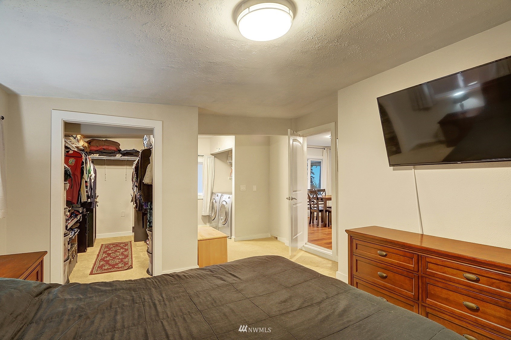 2209 Northeast 8th Street Renton, WA 98056 - Photo 12 of 24 a bedroom with a bed and a flat screen tv