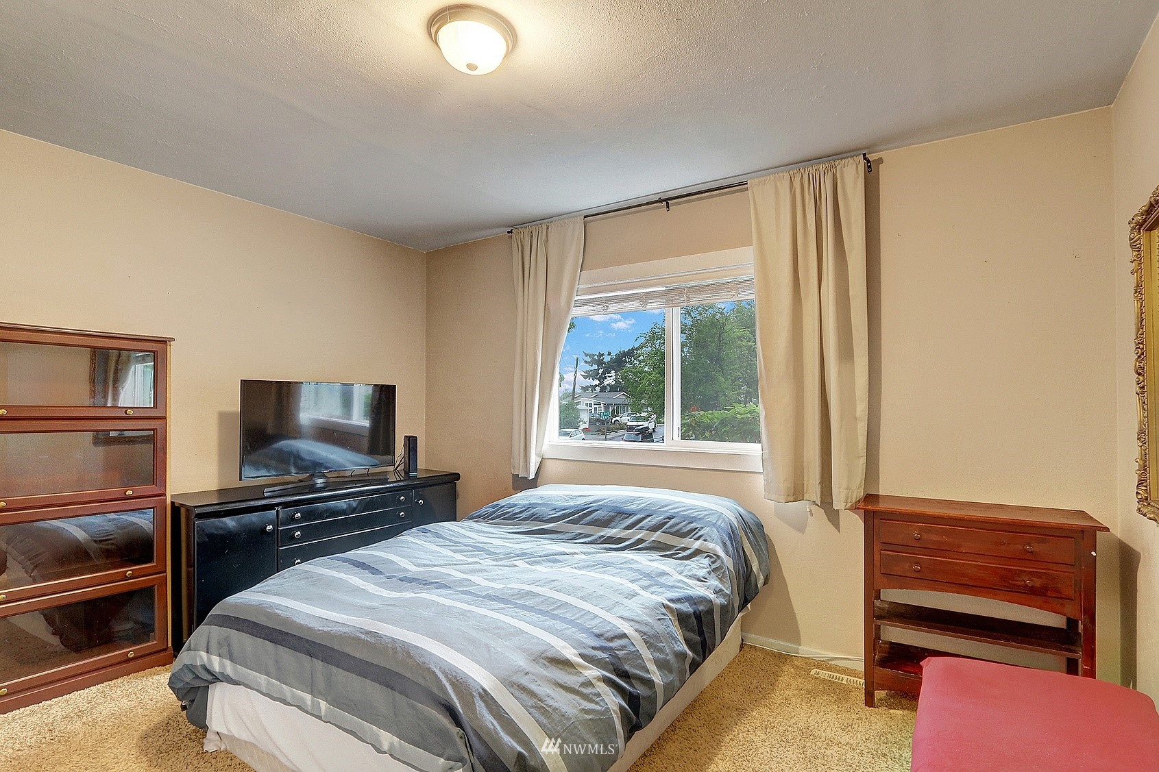 2209 Northeast 8th Street Renton, WA 98056 - Photo 13 of 24 a bedroom with a bed and a television