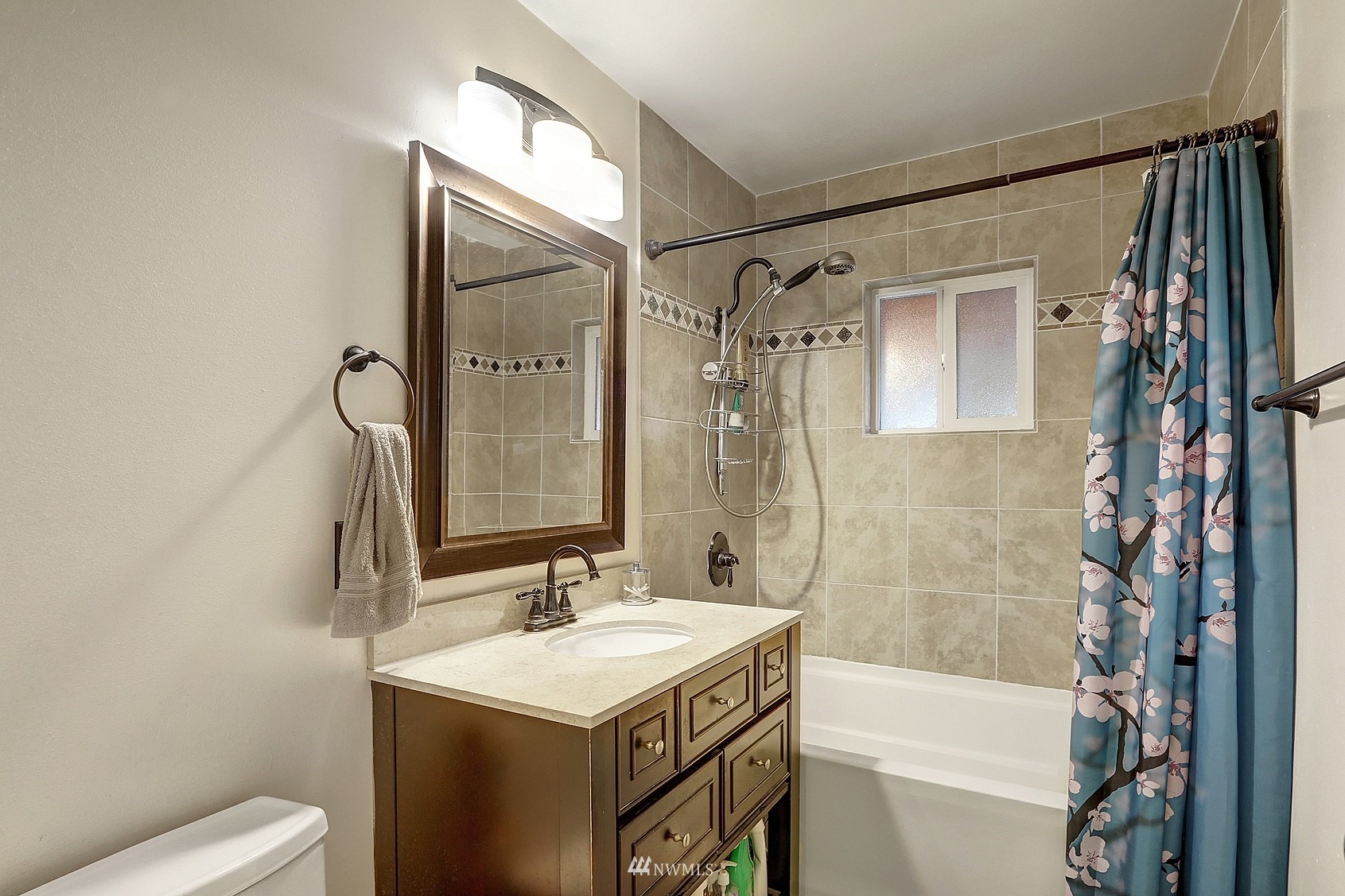 2209 Northeast 8th Street Renton, WA 98056 - Photo 14 of 24 a bathroom with a sink a toilet and shower