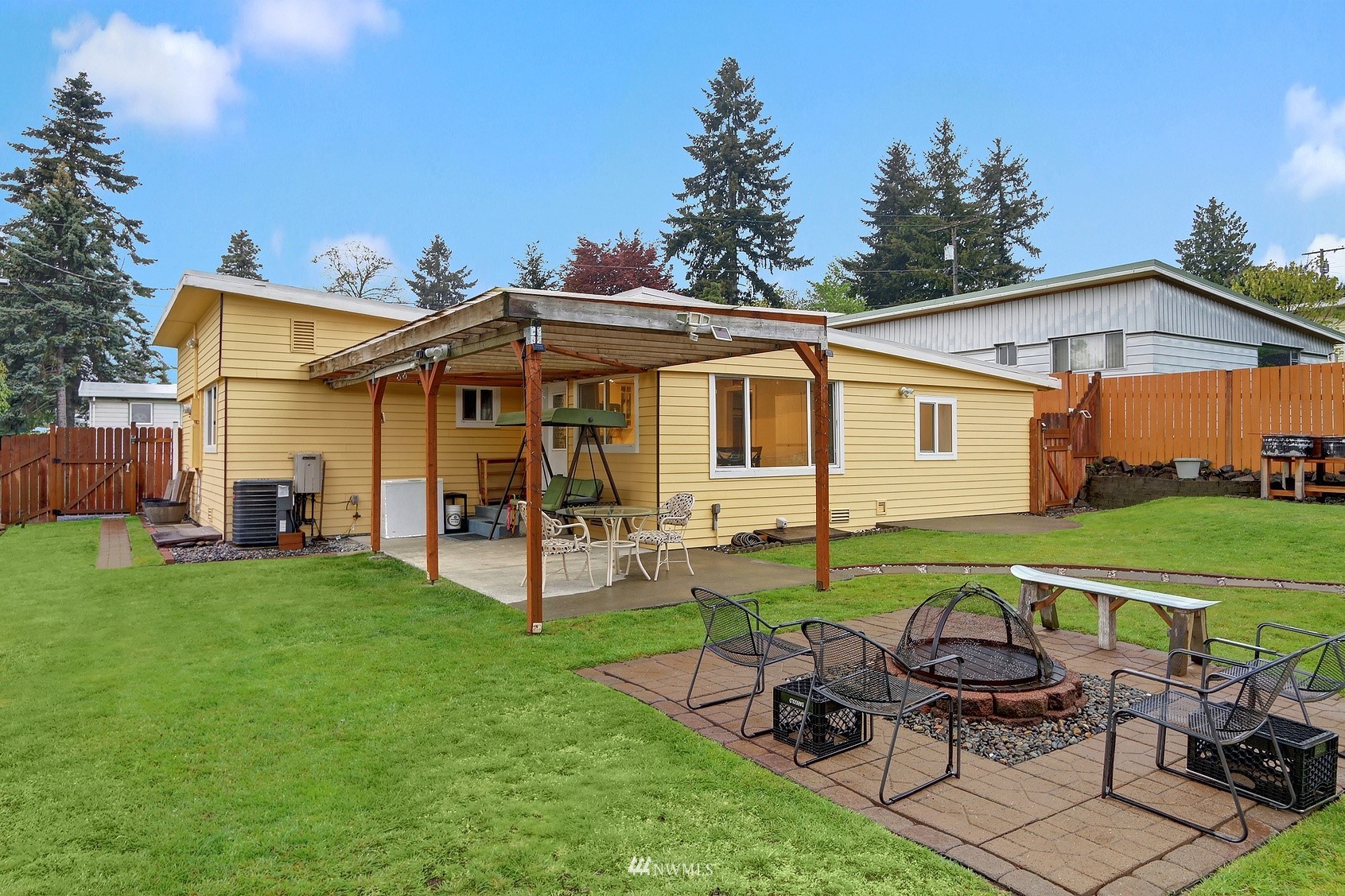 2209 Northeast 8th Street Renton, WA 98056 - Photo 17 of 24 a view of a house with backyard sitting area and garden