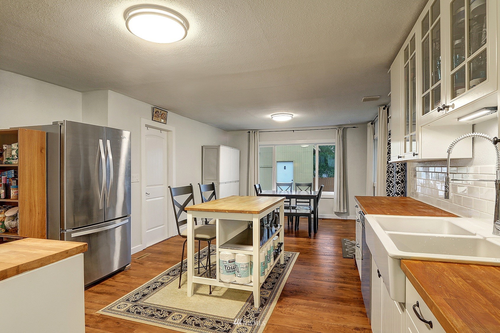 2209 Northeast 8th Street Renton, WA 98056 - Photo 3 of 24 a dining hall with stainless steel appliances granite countertop a dining table and chairs