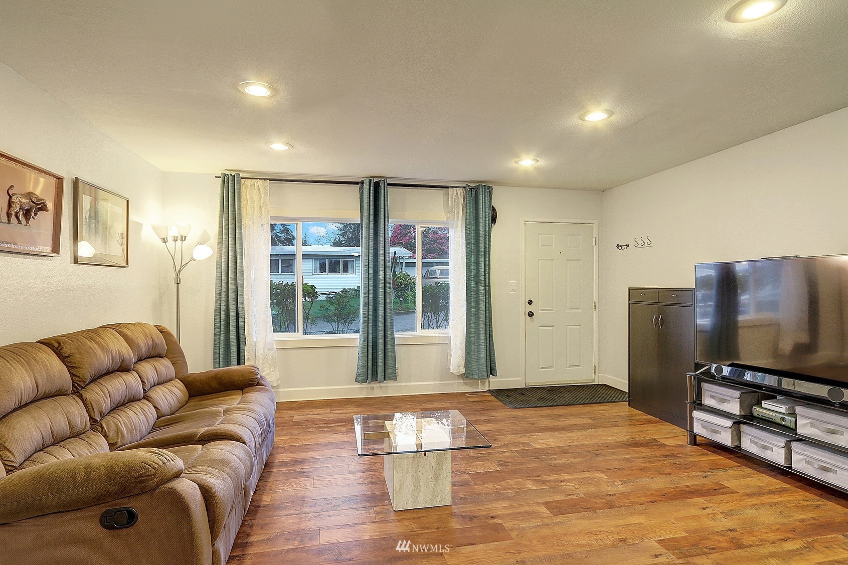2209 Northeast 8th Street Renton, WA 98056 - Photo 8 of 24 a living room with furniture and a flat screen tv